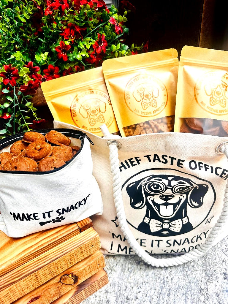 Dog treats in a canvas pouch with 'Chief Taste Officer' bags and a white bag in the foreground.