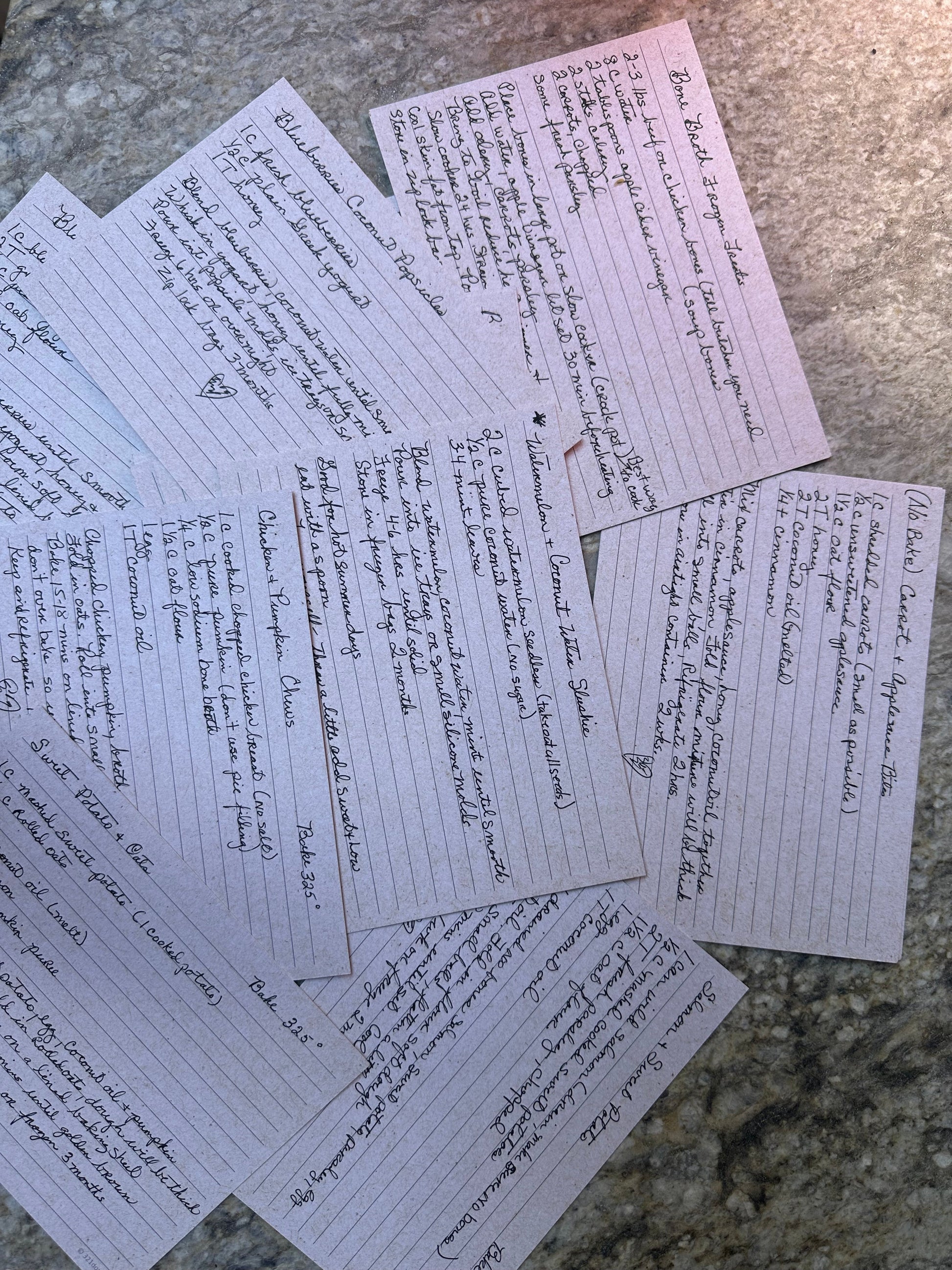 Full spread of all 20 handwritten recipe cards fanned out