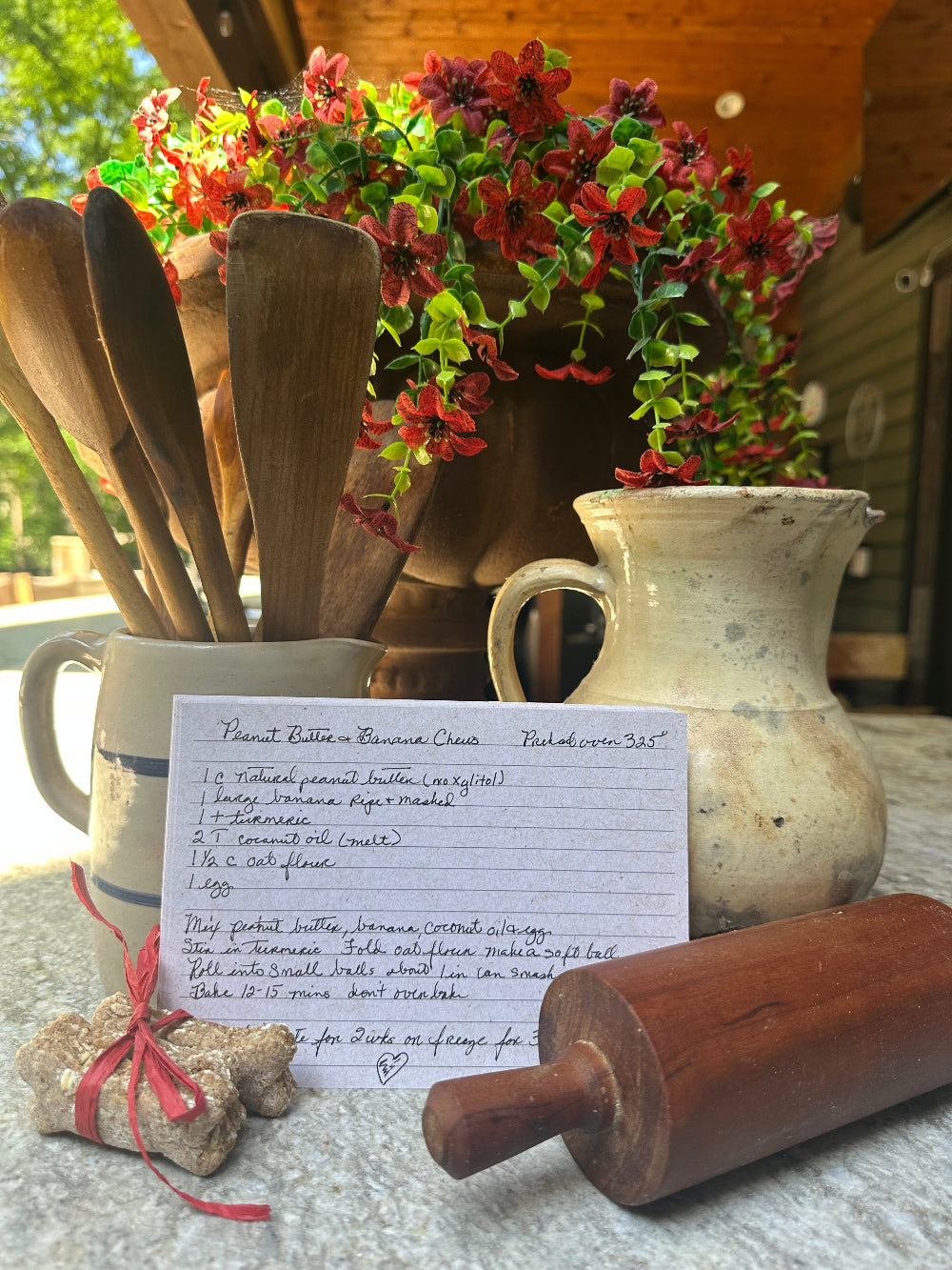Peanut Butter Banana Chews recipe card with wooden rolling pin and stoneware crocks