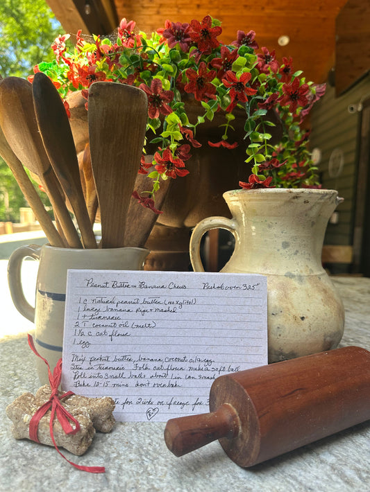 Peanut Butter Banana Chews recipe card with wooden rolling pin and stoneware crocks